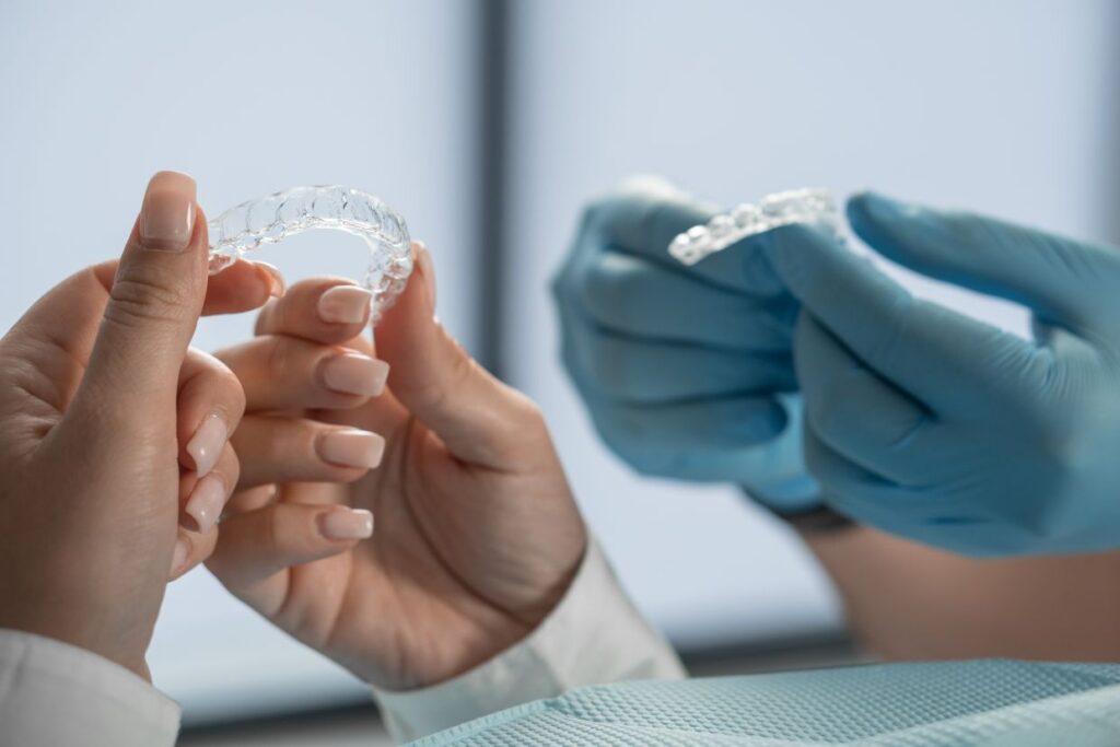 the hands of the doctor and the patient hold the invisalign