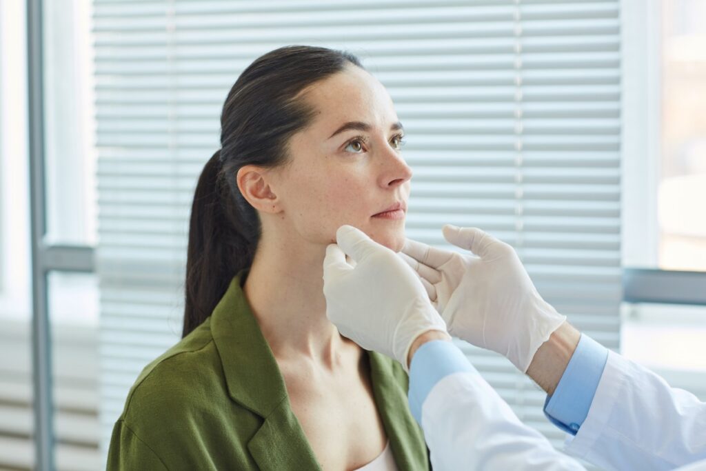 unrecognizable doctor examining female patient